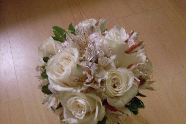 Bridesmaid bouquet of ivory roses and alstroemeria with gold wire and crystals. Also rhinestone monogram.