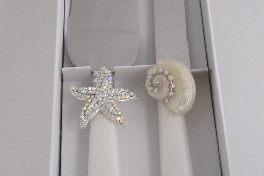 Seashore  Elegance  cake  server  set - $23.95 per setFaux  mother of pearl stainless steel  cake  server  set  hand  decorated  with  a  rhinestone  Starfish, pearlized  seashell  and  Swarovski  crystal  chain.This  cake  server  set  sparkles  like  the  sugar  sand  beaches  on  the  Gulf  Coast  of  Florida!
