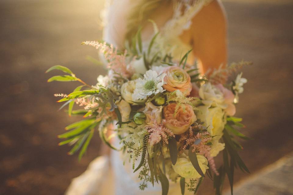 Whimsical Bouquet with wispy ranunculus, garden roses, astilbe and willow eucalyptus.