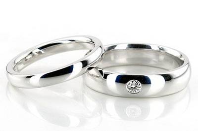 A classic, this his & hers Dome and Solitaire wedding ring set is great choice for lovers of simplicity and elegance. Solitaire band is set with 1 Round Cut Diamond in the center of the ring, which has a total carat weight of 0.08 ct. The diamond is graded G in color and SI1 in clarity. Rings are high polished.