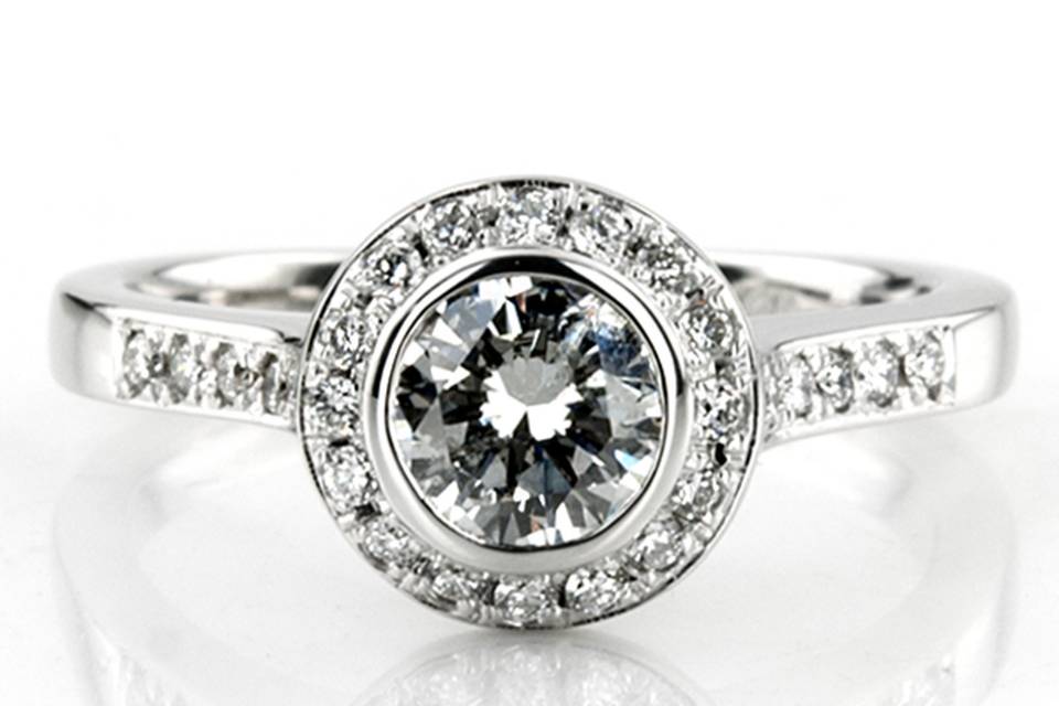 Stylish. This elegant bezel set diamond engagement ring is set with 36 round cut diamonds totaling 0.33 ct. tw. Bezel setting center can be set with 0.60 ct. - 0.85 ct. range round center diamond. This designer inspired diamond engagement ring is available in white gold, yellow gold, platinum or palladium.