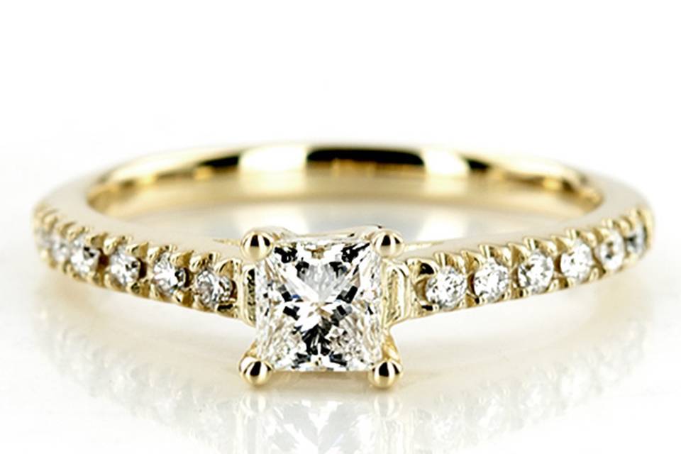 This gorgeous 0.12 ct.tw diamond engagement ring is set with 12 round cut diamonds. This diamond engagement ring can be set with a princess cut center stone. This ring is available in white gold, yellow gold, platinum or palladium.