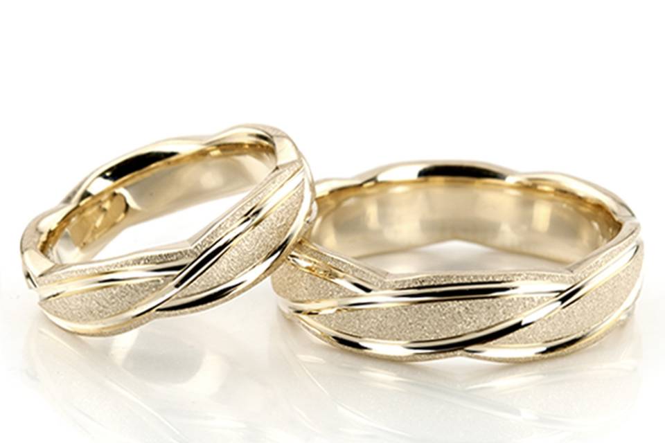 A sleek contemporary design, this 6mm wide Fancy Designer wedding ring set has curved uneven cuts, creating a beautiful style. This band is also available in 5, 7, 8, 9, 10mm. The band is stone finished, with bright cuts.
