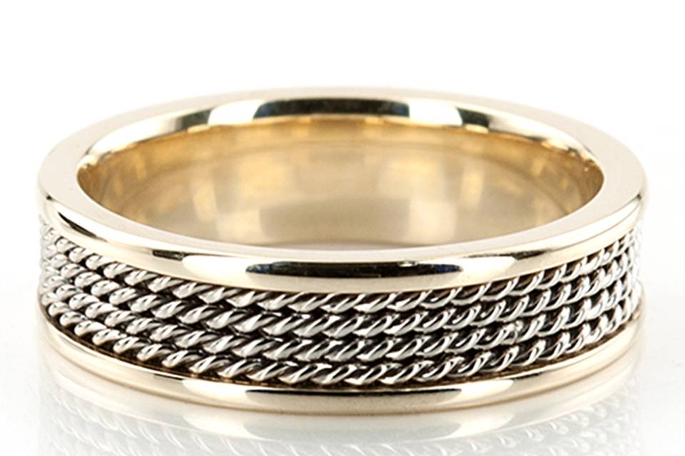 A gorgeous contemporary style, this 6mm wide Hand crafted wedding ring has four shiny rows of White Gold braids, and Yellow gold edges. Small braids in the center of the band are White Gold high polished. Each side are Yellow gold high polished.