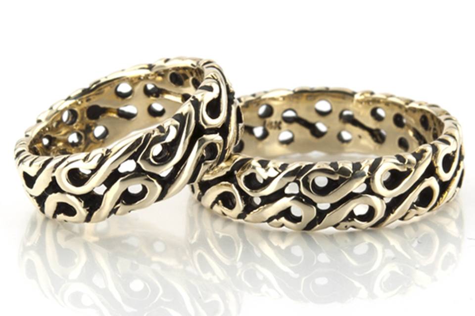 An exquisite Celtic design, this 6mm wide Handcrafted wedding band set has a traditional Celt motif with several holes. The band is high polished all around.