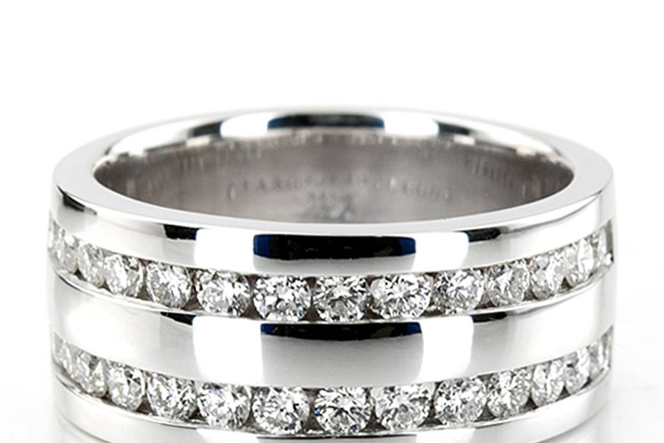 Double the power! This double row channel set diamond wedding band is set with 32 round cut diamonds totaling 0.96 ct.tw. This men's diamond wedding band is available in white gold, yellow gold, platinum or palladium.