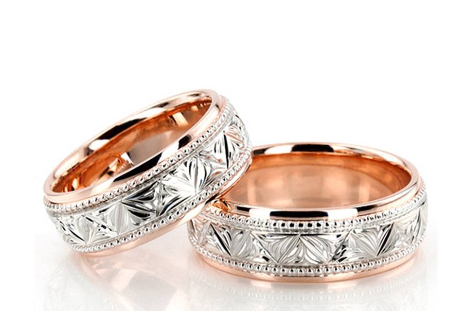 FC100956A contemporary style, this 7mm wide Floral Carved Wedding band set has a symmetrical leaf pattern and bead design at the edges. It's complete with step edges. The band is high polished.