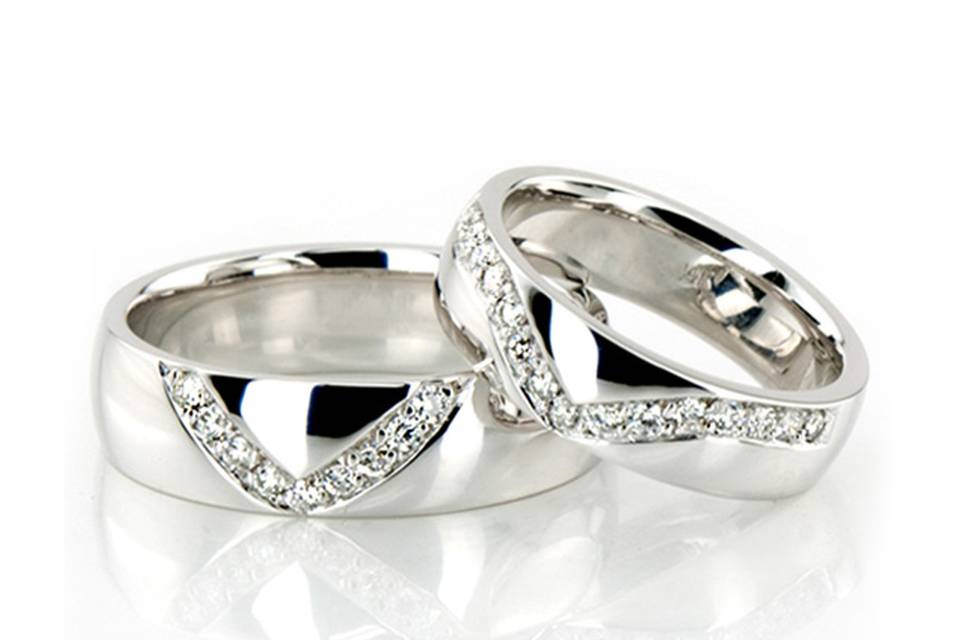 HH-107Lovely V shape channel set his & hers set. His ring is 6mm wide and set with 9 Round Brilliant Cut Diamonds. Each diamond weighs 0.015ct, total 0.135ct. Her ring is 5mm wide and set with 15 Round Brilliant Cut Diamonds. Each diamond weighs 0.015ct, total 0.225ct. The diamonds are graded G in color and SI1 in clarity. The band is high polished.
