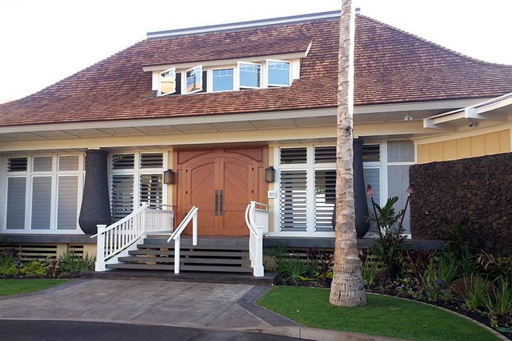 Front view of Maui wedding venue, Sugar Beach Events. The front of the building features a grand staircase and beautiful Hawaiian motif.  Ample parking is available in front area of wedding venue, also.