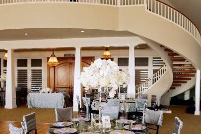 Interior of the wedding venue facing the front entryway.  Stairs lead up to a foyer.