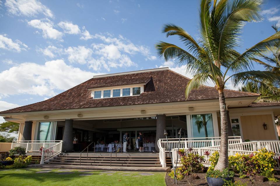 Front view of Maui wedding venue, Sugar Beach Events. The front of the building features a grand staircase and beautiful Hawaiian motif.  Ample parking is available in front area of wedding venue, also.