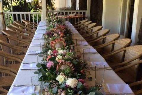 TABLE RUNNER-SEEDED EUCALYPTUS, WJITE & PINK ROSES & ROSE SPRAYS, WHITE DENDROBIUM ORCHID SPRAYS