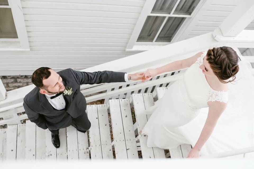 Simple wedding dress descending staircase