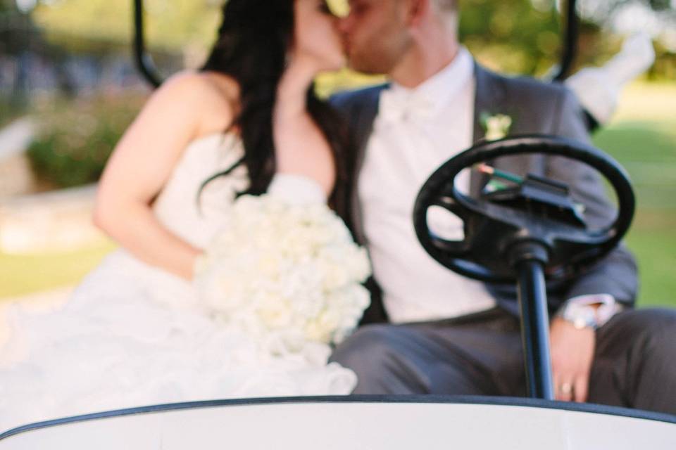 Kissing couple in golf cart