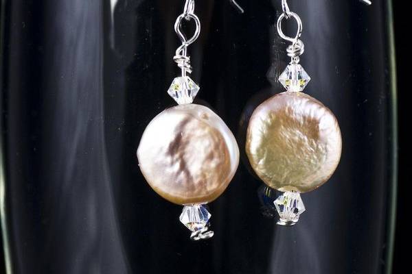 Coin pearls and  Swarovski crystal combine to create a delicate pair of dangley earrings.  Pearls are available in peach or white, crystals are available in a variety of colors.