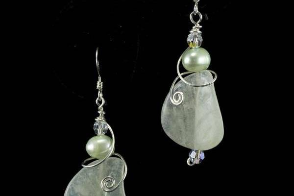 Pale green glass leaves and pearls are wrapped in a swirl of sterling silver in the delicate earrings.
