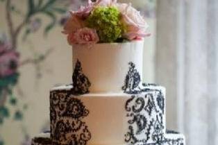 Cake topper of pink roses and hydrangeas.