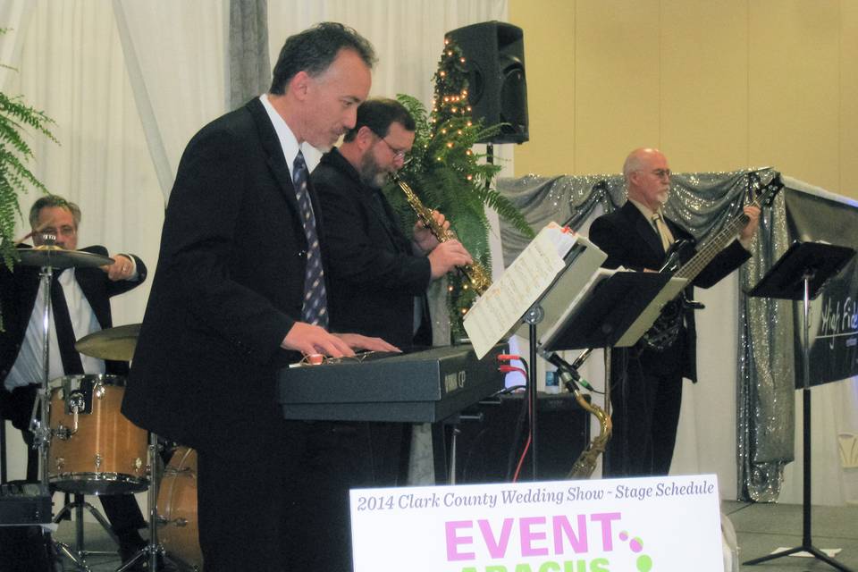 Photo of the UpFront quartet that features Steve on Sax, Chris on Keyboards and vocals, Robert on drums and Ed on bass.  Here we are playing at the Clark County Wedding Show.