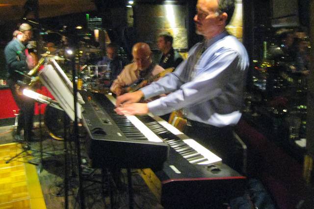 UpFront quintet performing at company Christmas party in the Portland City Grill in downtown Portland, OR.