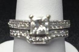 1 ct princess cut diamond with diamonds on shalk.  Wedding band custom made to match engagement setting