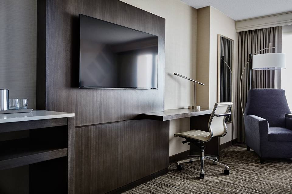 Guest rooms offer a workspace, flat screen televisions and seating.