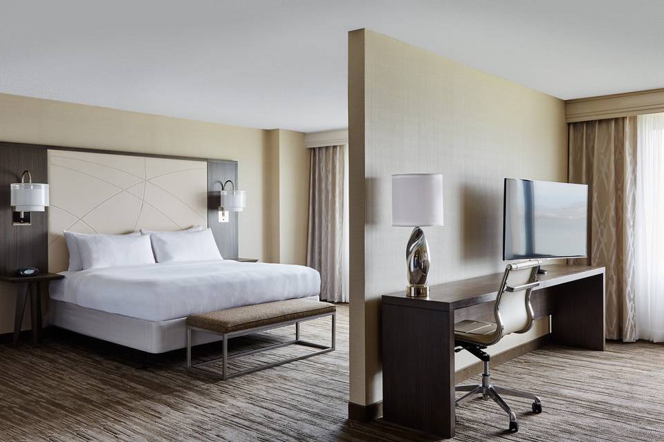 Guest rooms offer a workspace, flat screen televisions and seating.