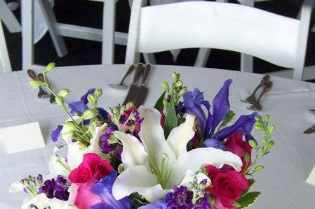 A colorful centerpiece created in a clear glass centerpiece. This was part of a beautiful tent wedding in Schaumburg, IL.