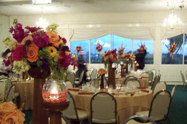 A close-up of the raised centerpieces at an October wedding at Palos Country Club.  Deep rich colors stand out against the neautral colors of the room.
