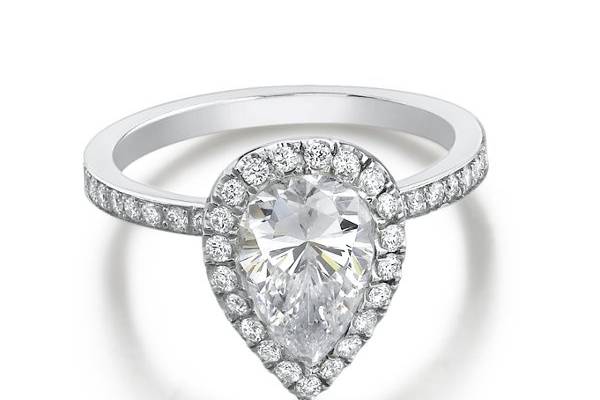 Handcrafted diamond engagement ring with a Pear shaped center diamond, surrounded with a halo of diamonds. All side diamonds are calibrated & matched for perfection. Available at Harold Steven's Jewelers