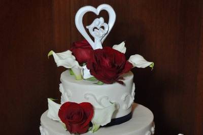 Three Tiered Buttercream with scroll-detailing, navy ribbon and fresh burgundy roses and calla lilies