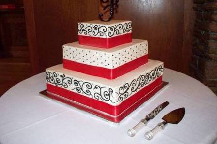 3-tiered square buttercream with hand-piped black scrolls make for a dramatic, elegant creation!