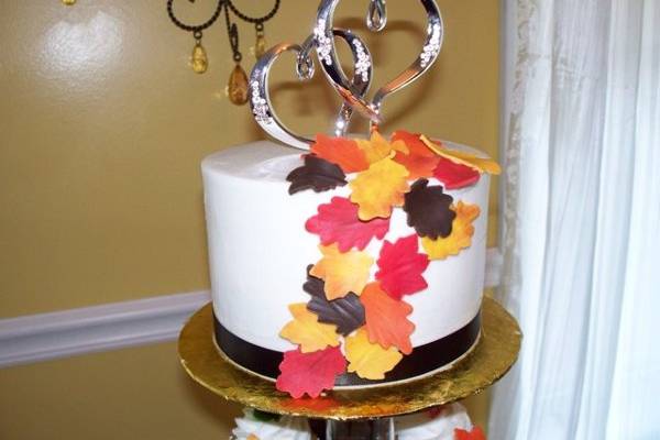 Fall Cupcake Wedding topper detail: Cascade of homemade fondant leaves adorn this cake used to keep with tradition of the cake cutting ceremony!