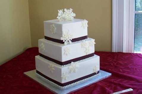 3 Tiered Buttercream  Snowflake Wedding Cake.  Vanilla cake, raspberry filling and hand-piped buttercream white chocolate snowflakes dusted with edible shimmer!