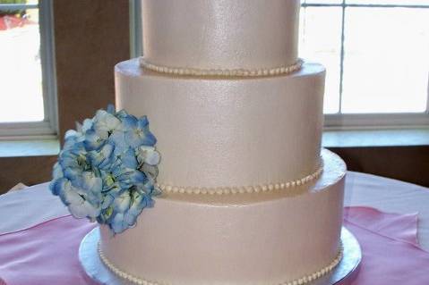 Ivory Buttercream Hydrangea Cake with hand-piped buttercream beading, and fresh hydrangea pompom, and pearlized with edible pearl luster!