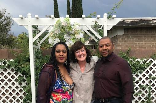 Happy couple and officiant