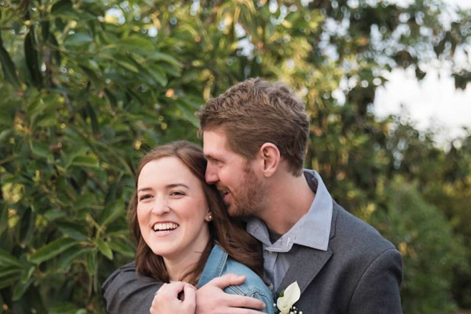 Groom embraces his bride