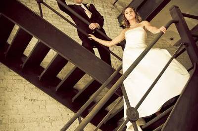 Bridal portrait of bride and groom on old staircase at Rockford IL's Prairie Street Brewhouse.
