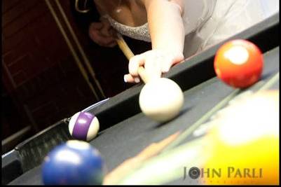 Fun image with bride and groom shooting pool at Union Station in Joliet IL