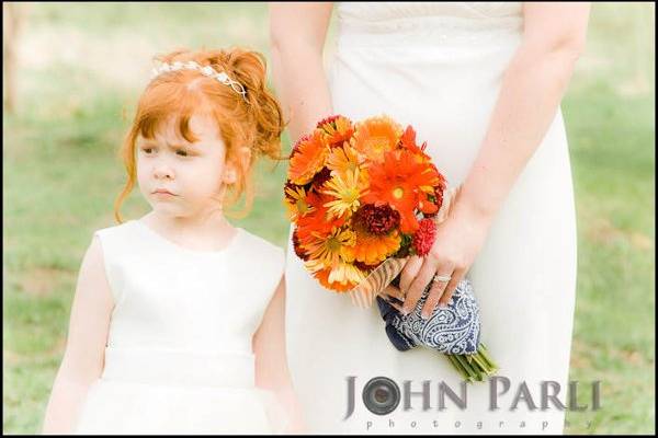 flower girl with bride at outdoor ceremony