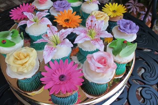 Beautiful Floral Cupcakes.  Handmade sugar paste Stargazer lilies, Roses and Gerbera Daisies.  Perfect for a garden wedding!