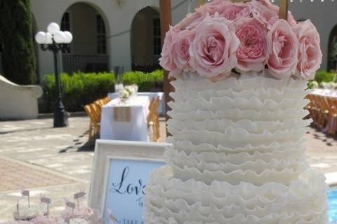 Ruffled Wedding Cake with Fresh Pink Roses and pretty cupcakes for a wedding at St. Vincents in San Rafael.