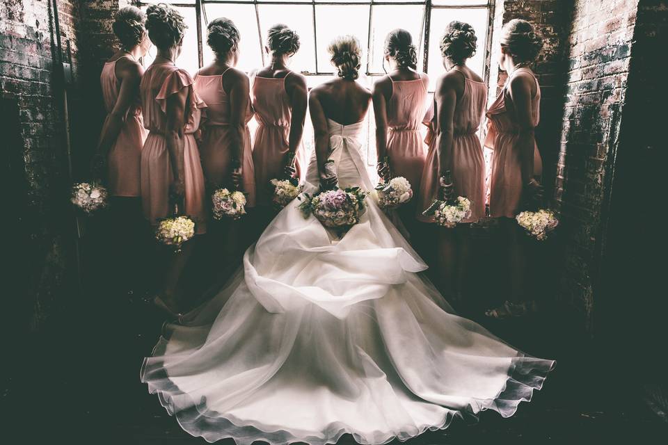 Bride and Bridesmaids silhouetted at the McKinney Cotton Mill.