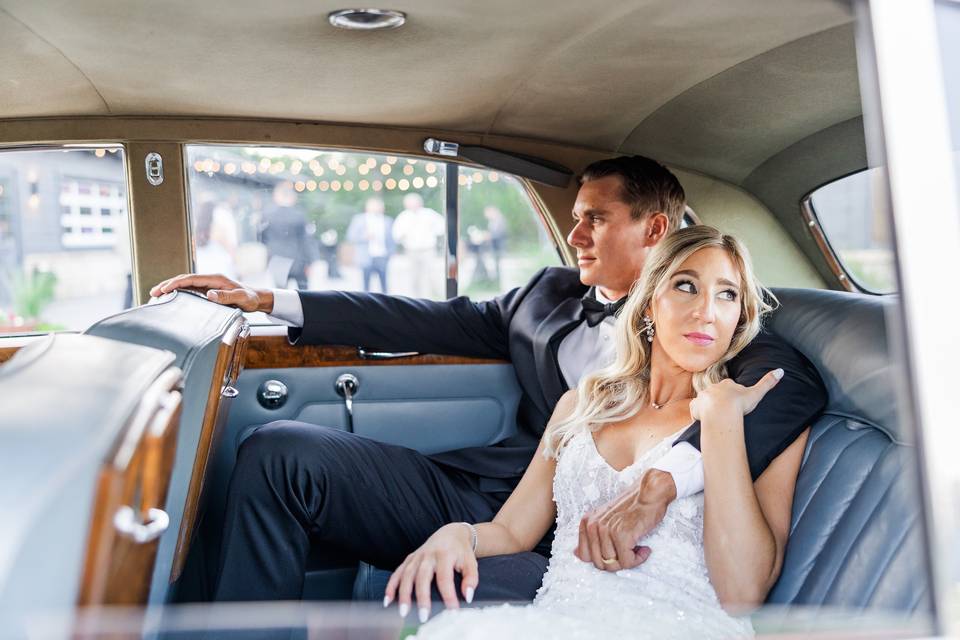 Bride and groom in vintage car