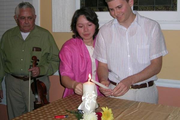 The newlyweds with the wedding officiant