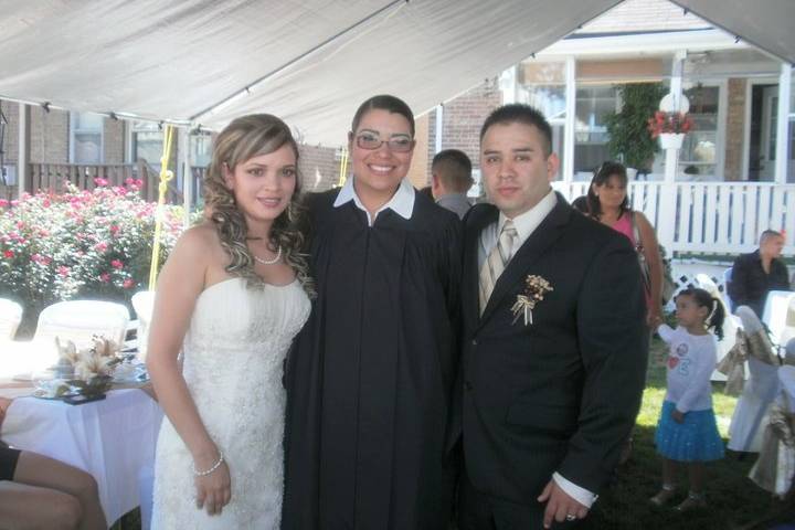 The newlyweds with the wedding officiant