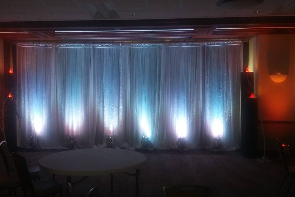 White drape lighting and orange uplights