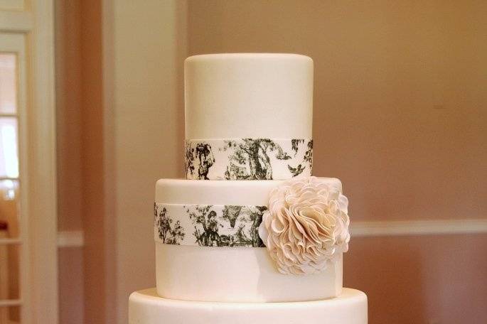 Wedding cake with fondant Toile ribbons and stylized flower