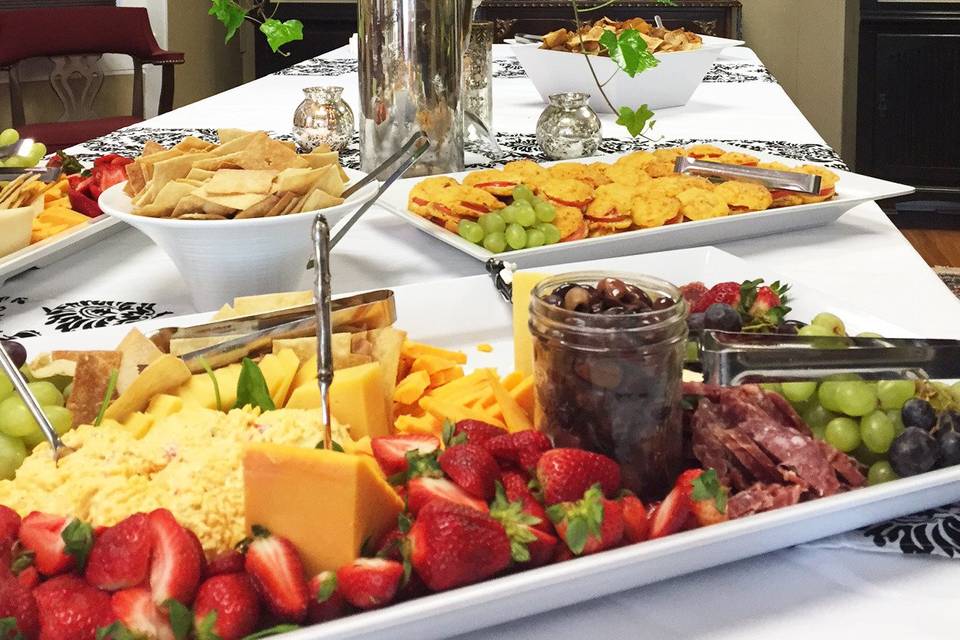 Beautiful buffet table with flowers and food.