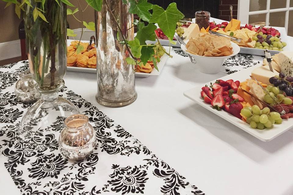 Buffet and flower, plus monogram decorating the mantle.