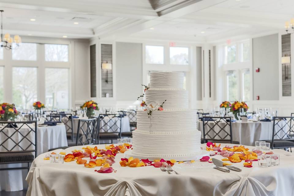 Wedding cake table decorated in petals